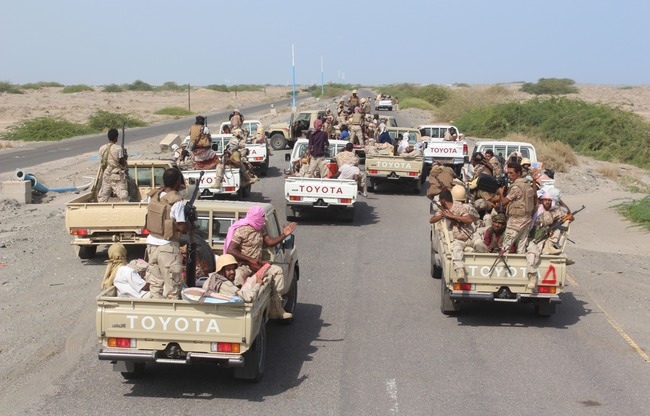 Yemeni pro-government forces ride military vehicles, as they head to Zinjibar, the capital of Yemen's southern province of Abyan, to launch an offensive to recapture the town from al-Qaeda jihadists on August 14, 2016.
Yemeni pro-government forces, backed by Saudi-led air strikes, entered Zinjibar as they launched an offensive to recapture the southern Abyan province and its capital from Al-Qaeda jihadists. / AFP PHOTO / SALEH AL-OBEIDI